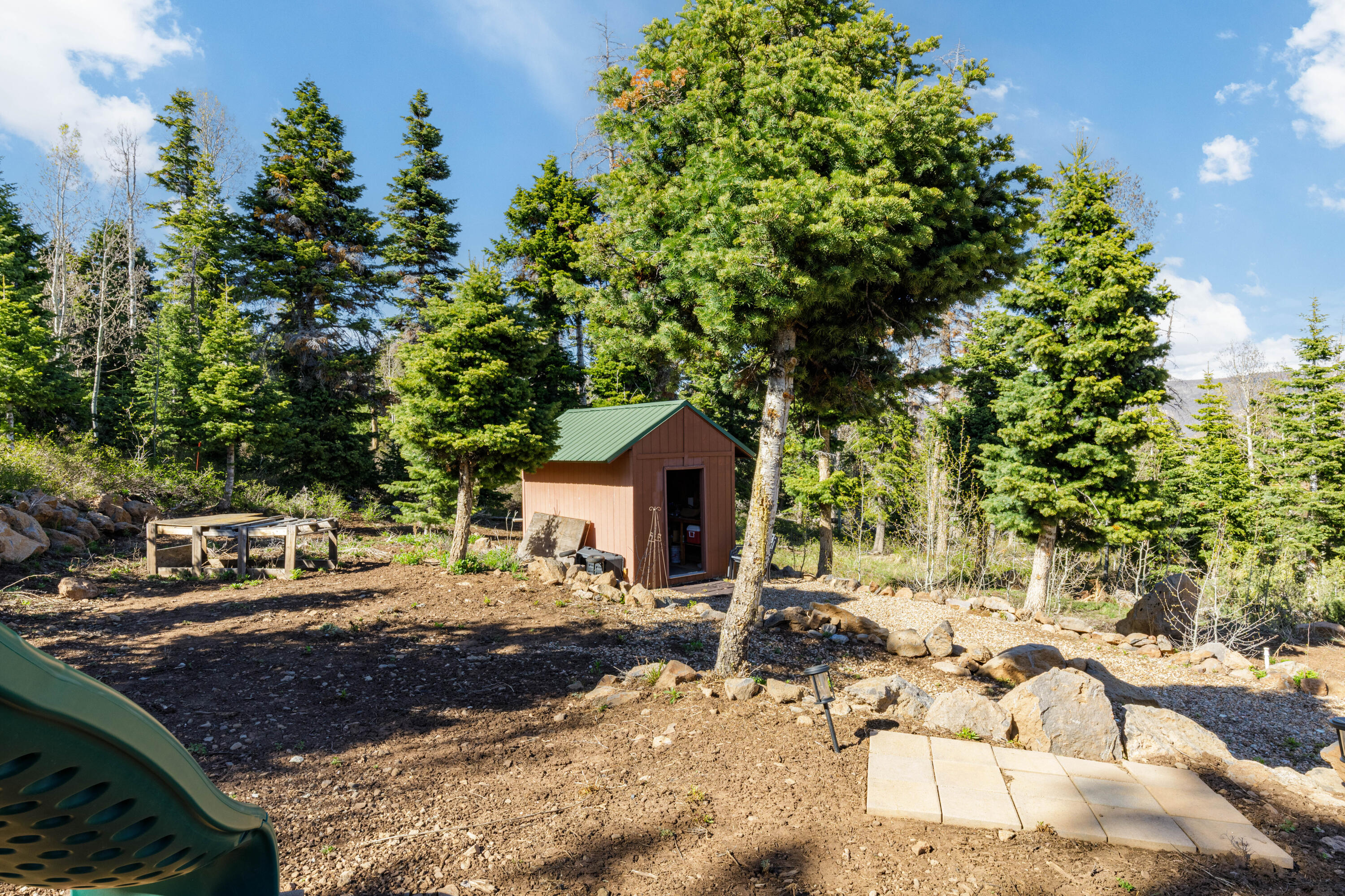 706 West Tranquility Drive Springdale, UT 84767 - Photo 28 of 58 Scenic Property Grounds: A beautiful view of the leveled lot, mature evergreens, and additional storage shed.