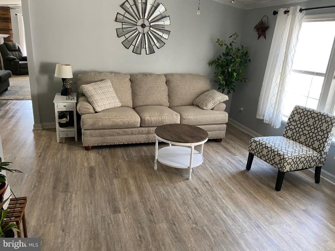14 Thomas Lane Sparrows Point, MD 21219 - Photo 23 of 26 a living room with furniture and a wooden floor