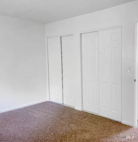 a bathroom with a white toilet and a glass door