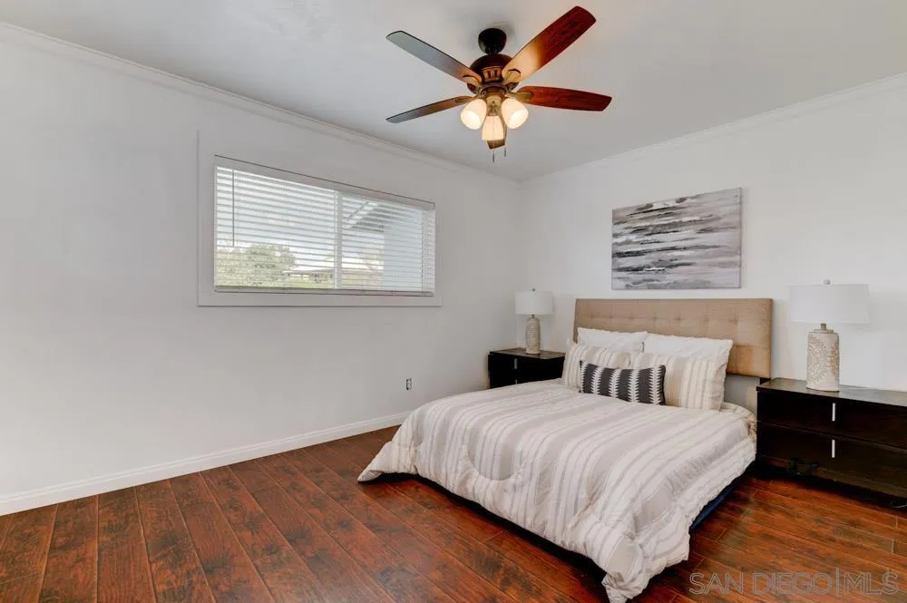 1105 Hamlet Drive El Cajon, CA 92021 - Photo 16 of 26 a bedroom with a large bed and a chandelier