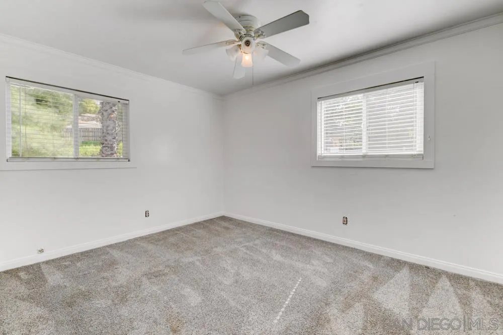 1105 Hamlet Drive El Cajon, CA 92021 - Photo 17 of 26 an empty room with a window and a ceiling fan