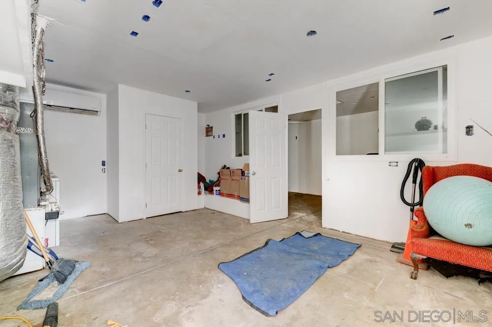 1105 Hamlet Drive El Cajon, CA 92021 - Photo 18 of 26 a bedroom with a bed and a chandelier