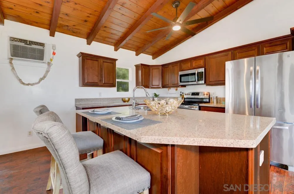 1105 Hamlet Drive El Cajon, CA 92021 - Photo 6 of 26 a kitchen with stainless steel appliances granite countertop a sink a microwave refrigerator and a stove
