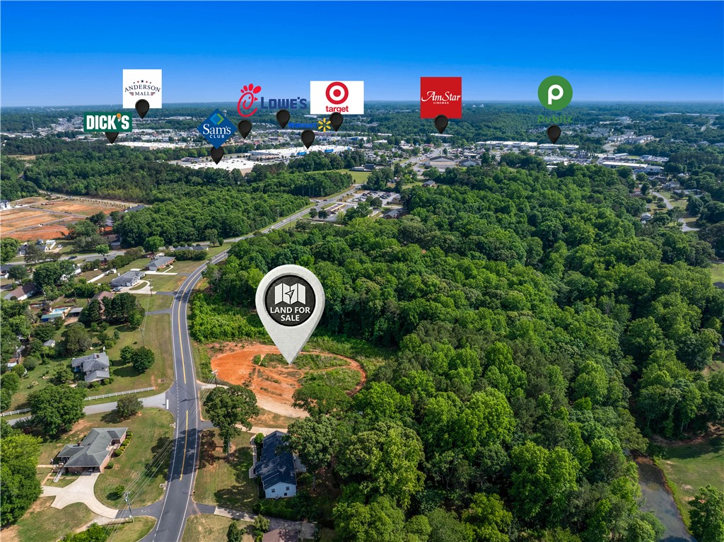 0 Brown Road Anderson, SC 29621 - Photo 6 of 9 Vast, verdant acreage awaits development, offering direct road access and prime proximity to established retail.