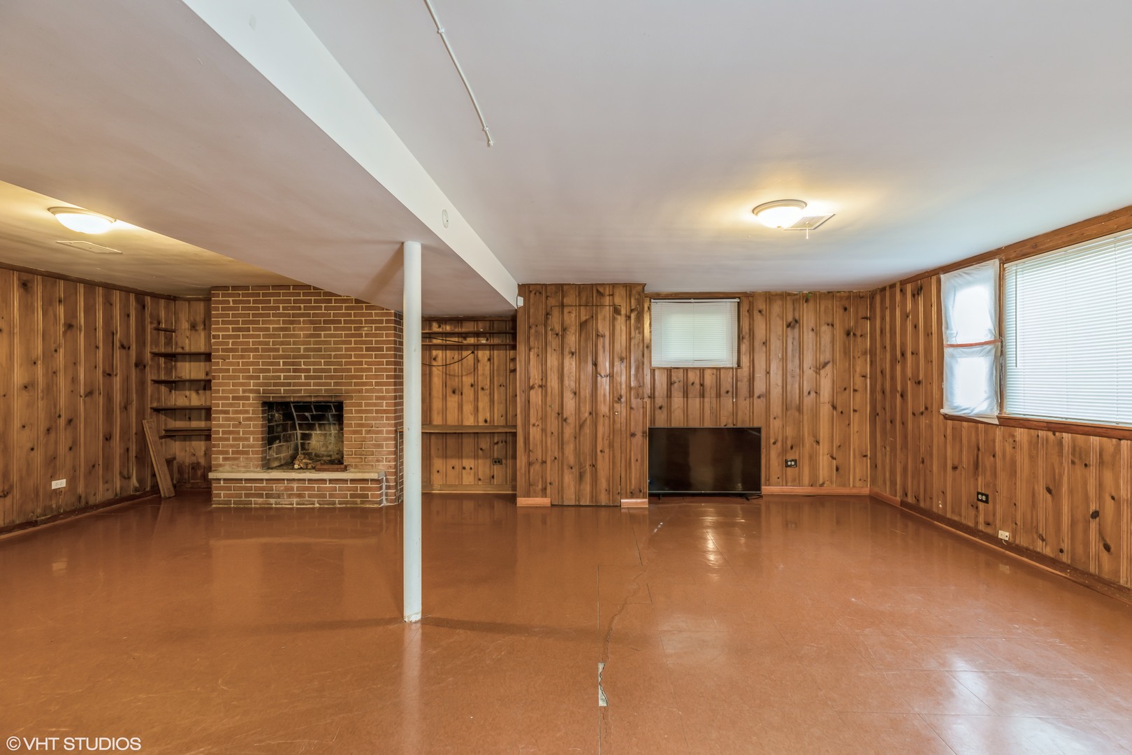 828 Exmoor Road Olympia Fields, IL 60461 - Photo 6 of 9 an empty room with windows fireplace and cabinet