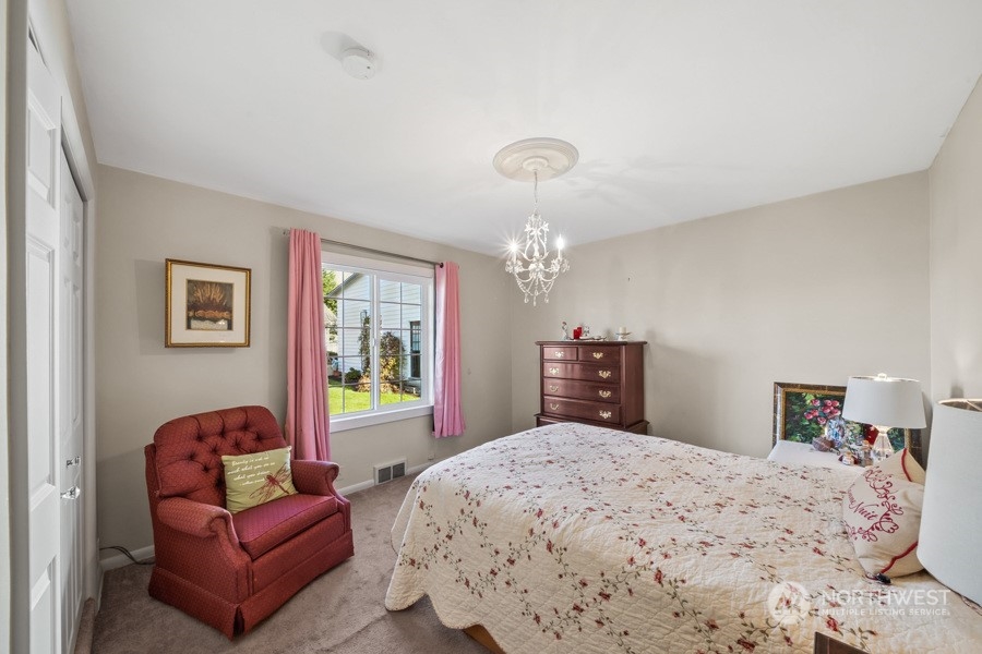 2007 Park Enumclaw Wa 98022 Enumclaw, WA 98022 - Photo 18 of 34 a bedroom with a large bed and a chandelier