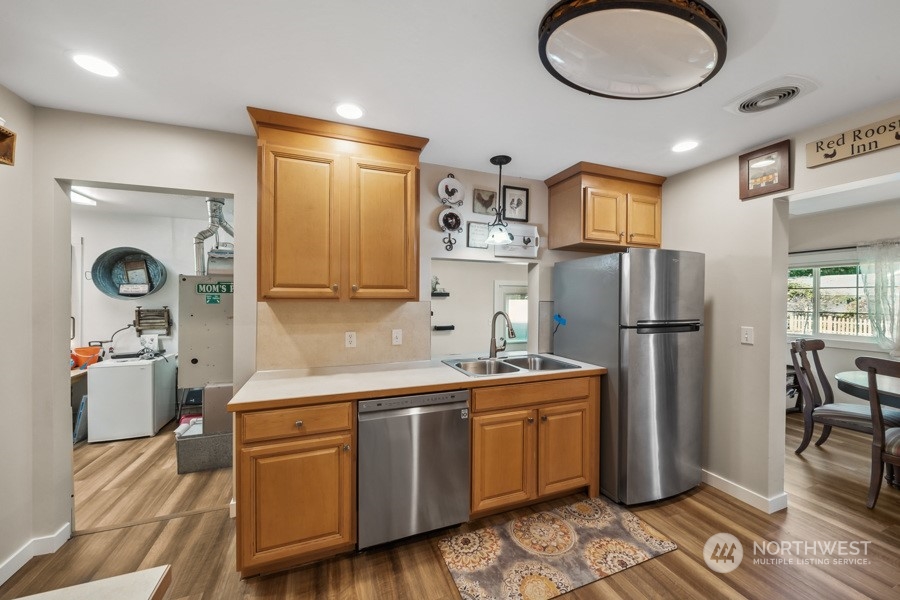 2007 Park Enumclaw Wa 98022 Enumclaw, WA 98022 - Photo 9 of 34 a kitchen with a sink stainless steel appliances a refrigerator and cabinets