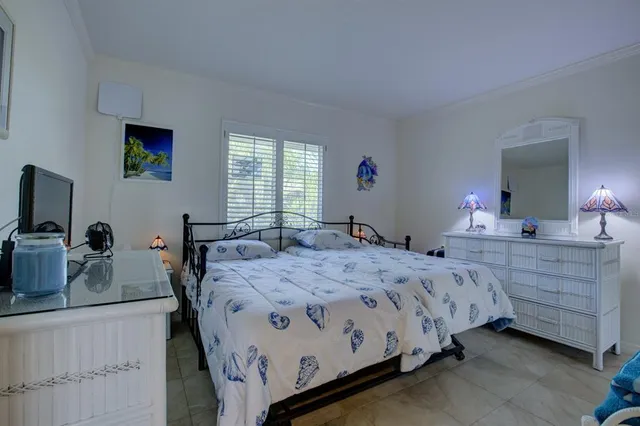 a bedroom with a bed and a dresser in it