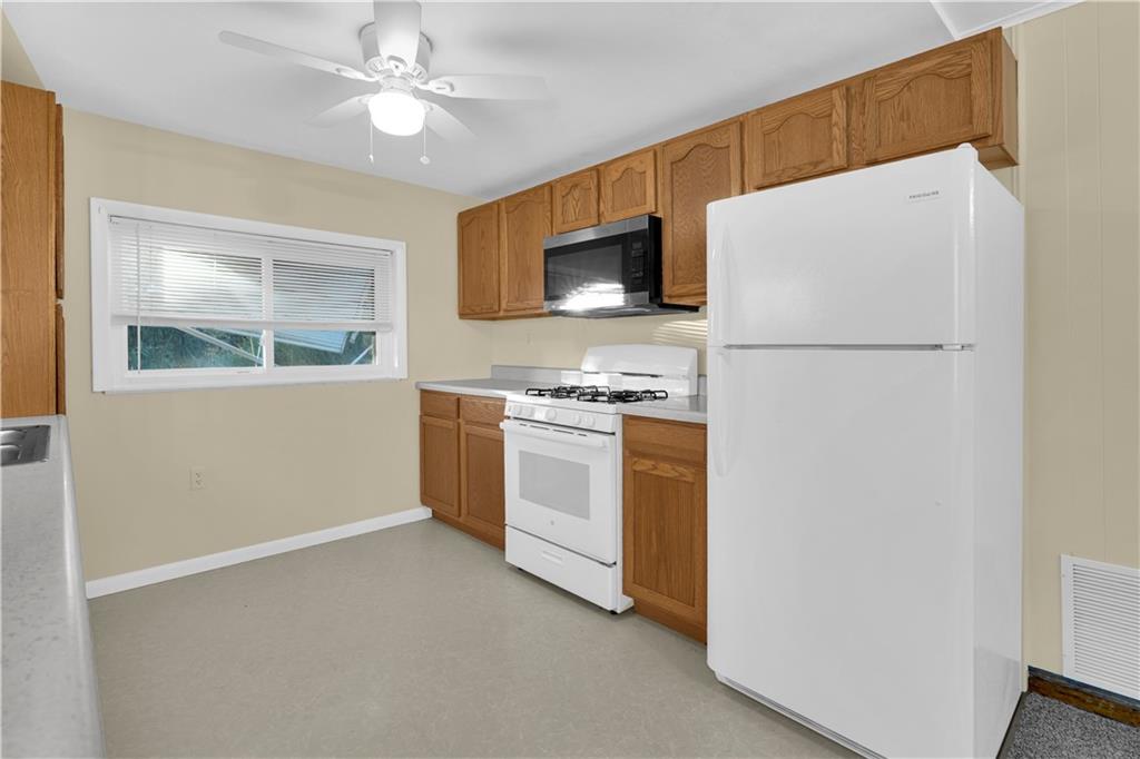 2071 Brodhead Road Aliquippa, PA 15001 - Photo 17 of 30 a kitchen with a refrigerator and a stove