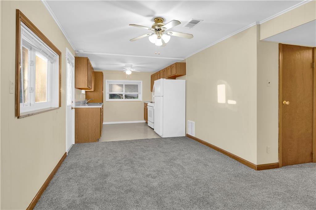 2071 Brodhead Road Aliquippa, PA 15001 - Photo 19 of 30 a view of a kitchen with furniture and a ceiling fan