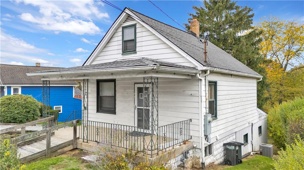 2071 Brodhead Road Aliquippa, PA 15001 - Photo 2 of 30 a view of small white house with large windows and plants