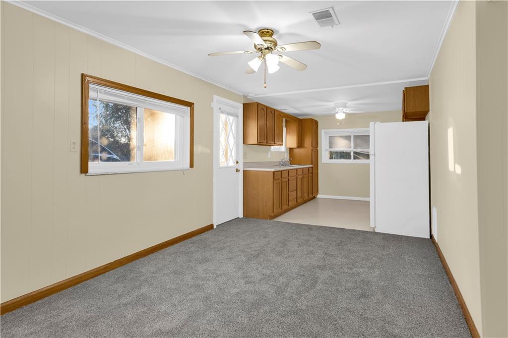 2071 Brodhead Road Aliquippa, PA 15001 - Photo 22 of 30 a view of a kitchen with a stove cabinets a ceiling fan and wooden floor