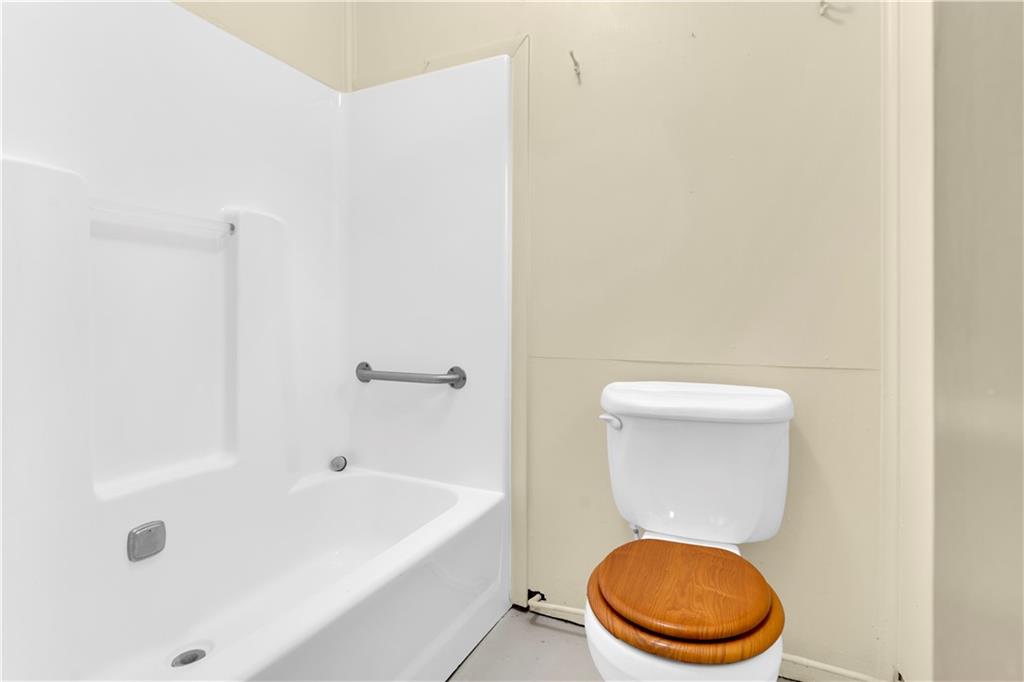 2071 Brodhead Road Aliquippa, PA 15001 - Photo 25 of 30 a white toilet sitting next to a bath tub