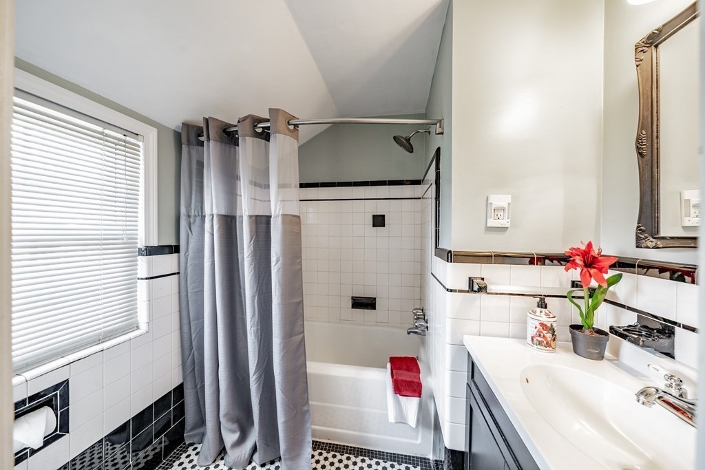 139 Abbott Street Springfield, MA 01118 - Photo 15 of 36 a bathroom with a tub sink and mirror