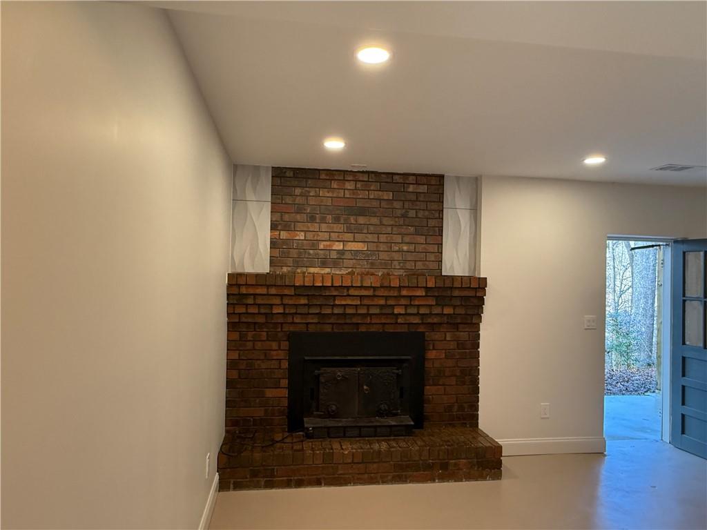 456 Poverty Road, Unit B Murrayville, GA 30564 - Photo 10 of 21 a living room with a fireplace and a wooden floor
