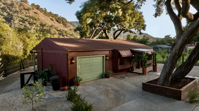 a living room with fireplace furniture and a large window