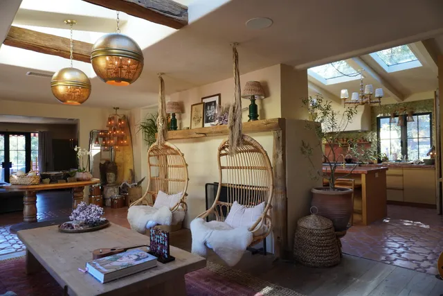 a room with furniture and view of kitchen