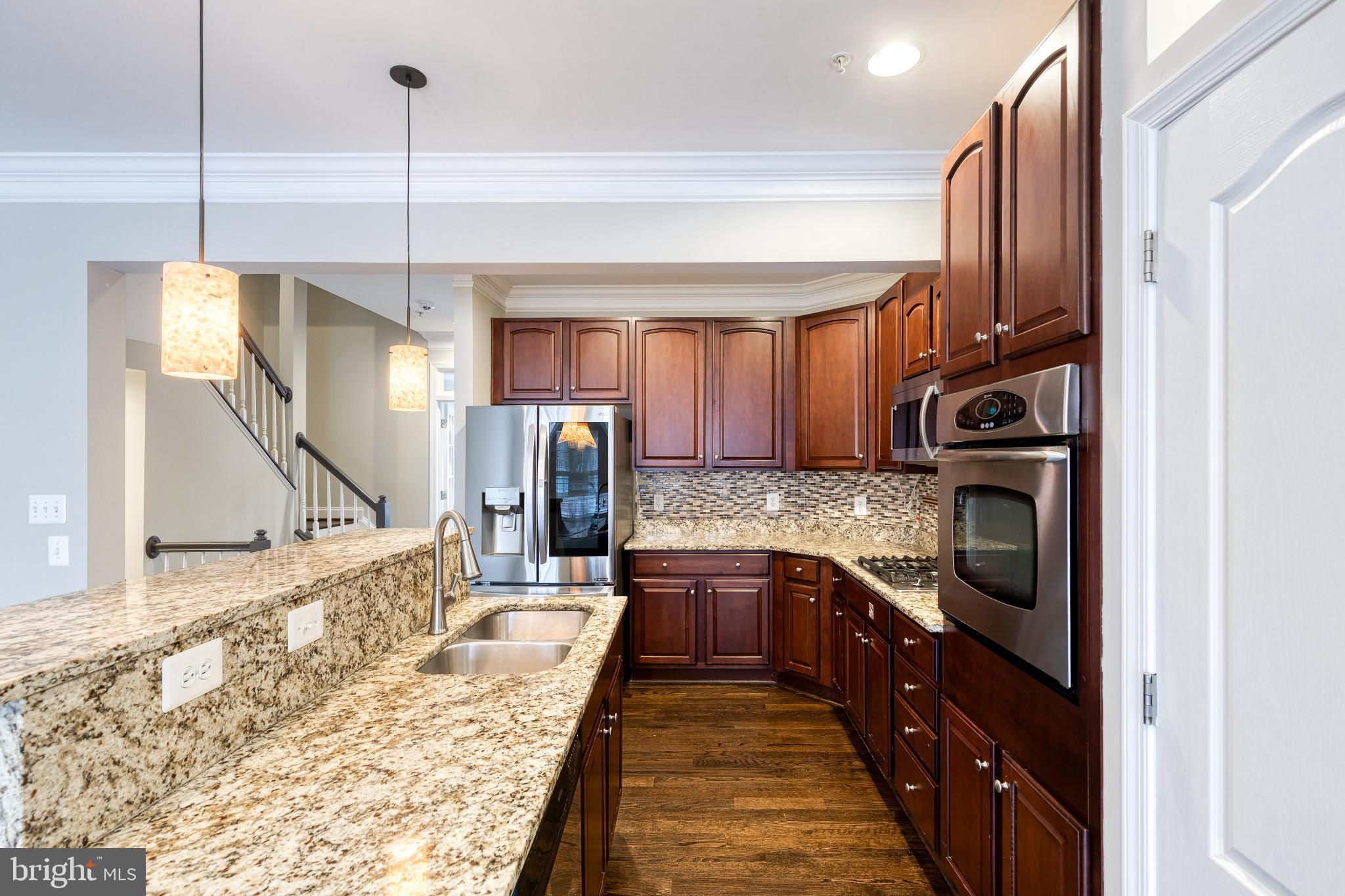 3307 Fait Avenue Baltimore, MD 21224 - Photo 12 of 26 a kitchen with granite countertop a sink a counter top space appliances and cabinets