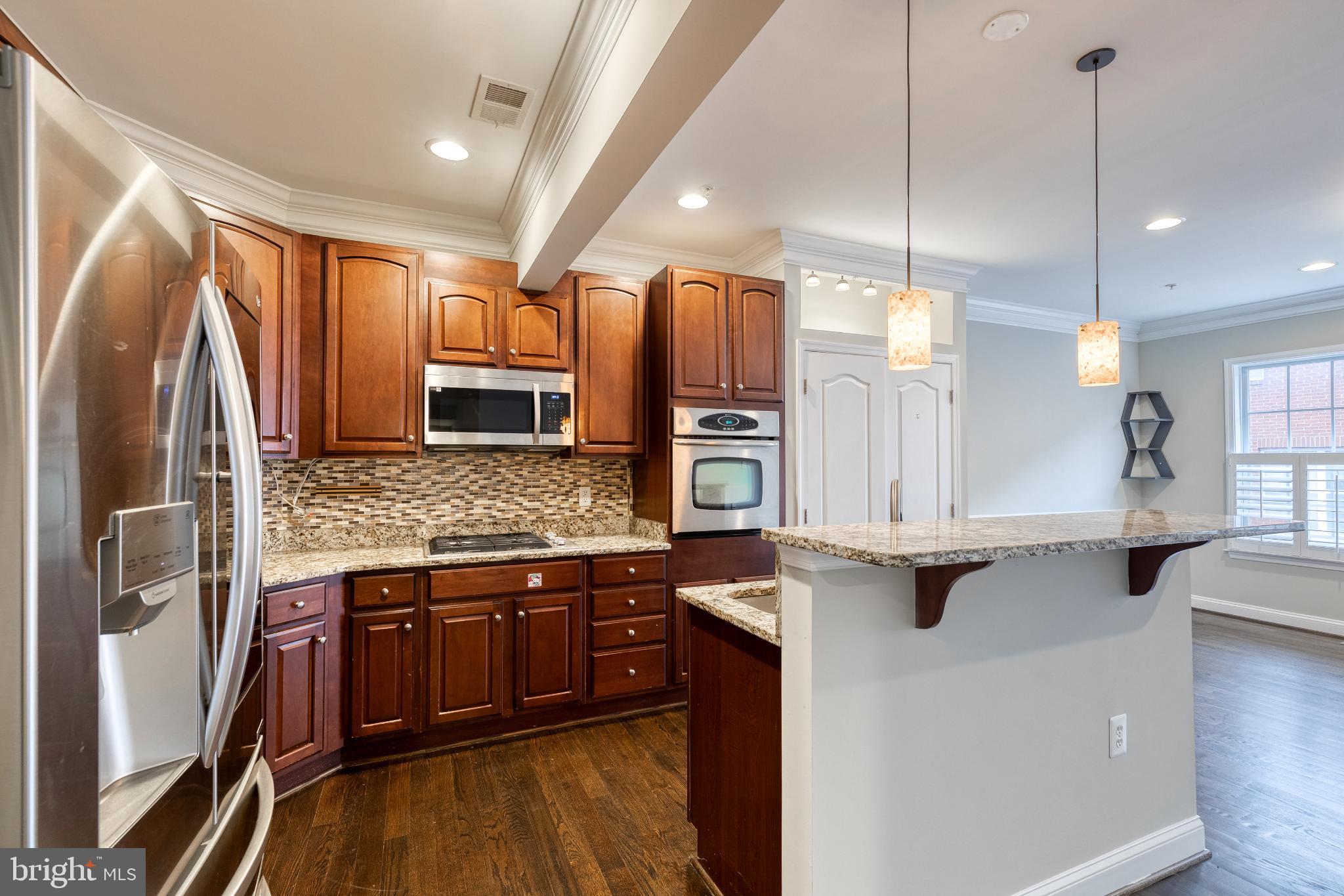 3307 Fait Avenue Baltimore, MD 21224 - Photo 13 of 26 a kitchen with stainless steel appliances granite countertop a sink a stove and a refrigerator