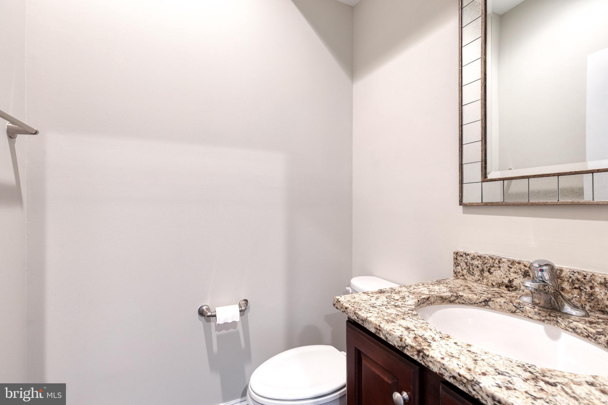 3307 Fait Avenue Baltimore, MD 21224 - Photo 16 of 26 a bathroom with a granite countertop sink and a mirror