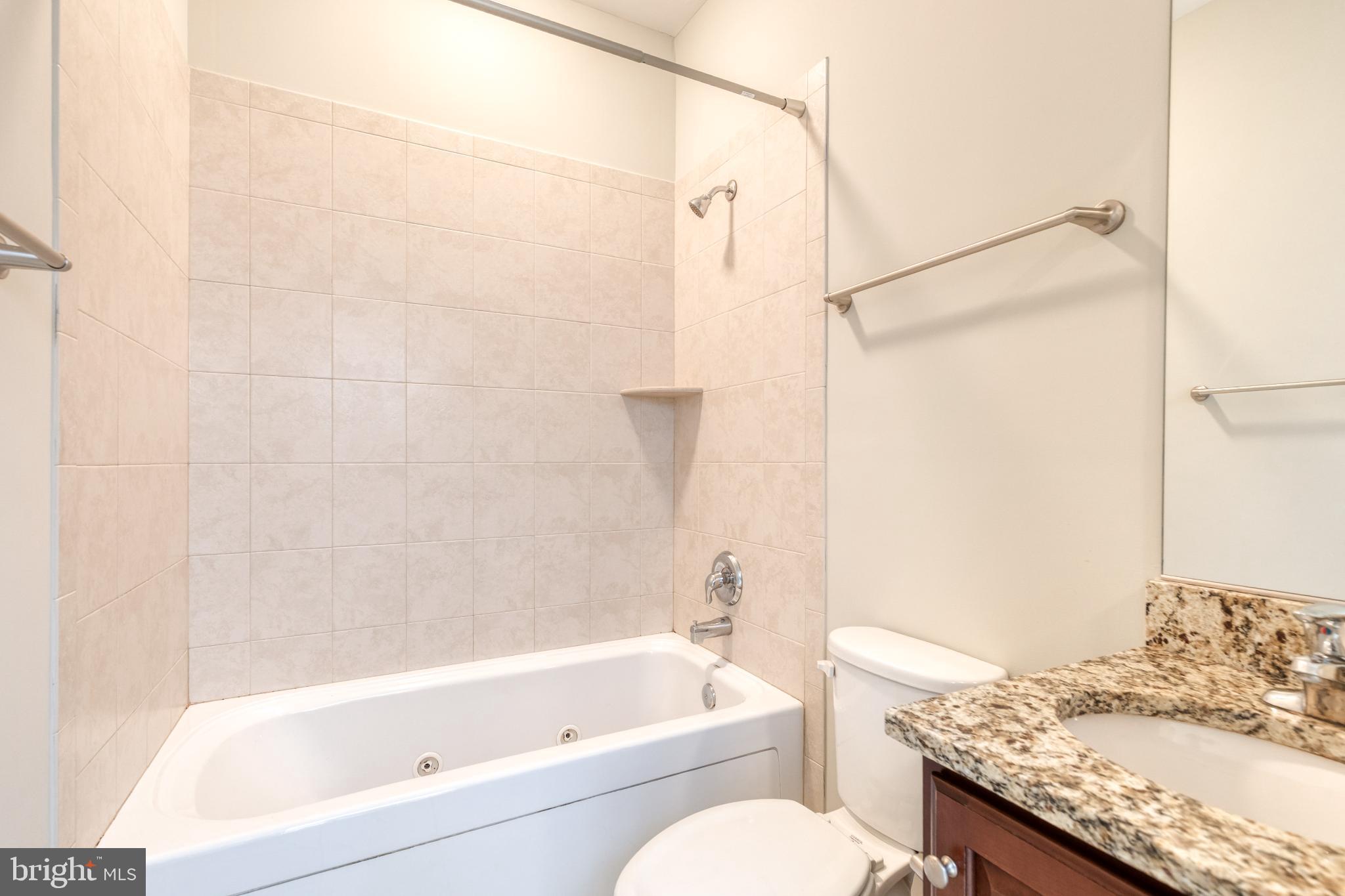 3307 Fait Avenue Baltimore, MD 21224 - Photo 22 of 26 a bathroom with a granite countertop bathtub shower sink vanity and toilet