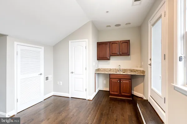 a kitchen with granite countertop a stove and a refrigerator