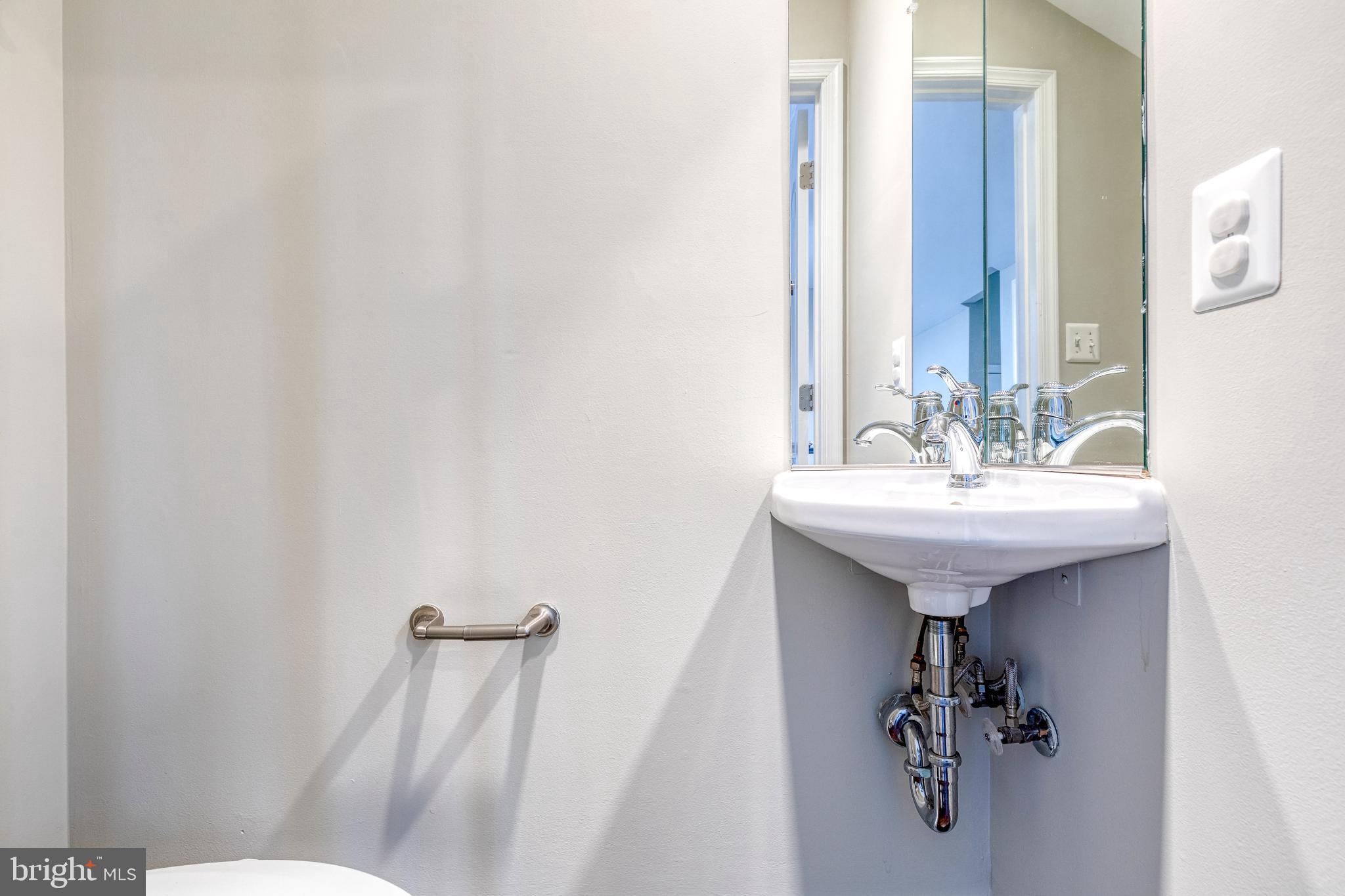 3307 Fait Avenue Baltimore, MD 21224 - Photo 24 of 26 a bathroom with a sink toilet and mirror