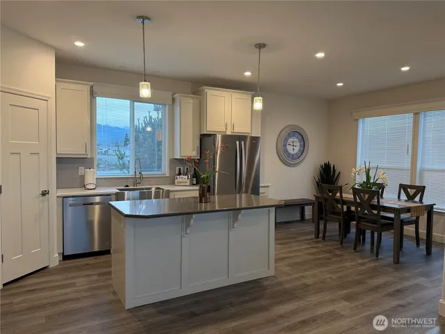 a large kitchen with a table and chairs
