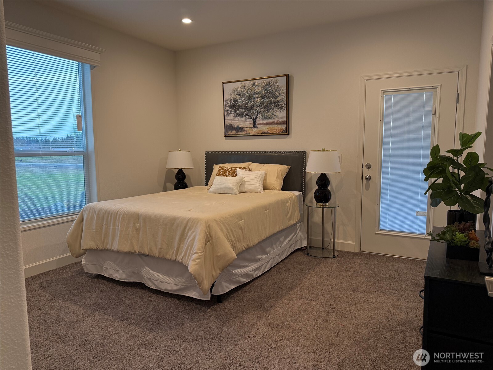 Undisclosed Address Sequim, WA 98382 - Photo 6 of 10 a bedroom with a bed table and a potted plant