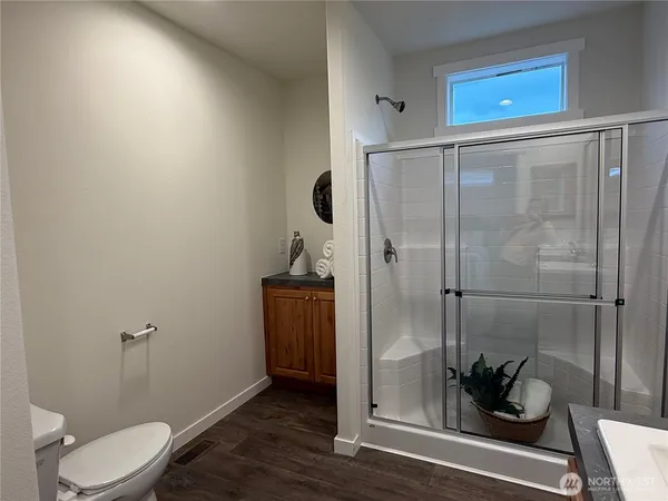 a bathroom with a toilet and a shower