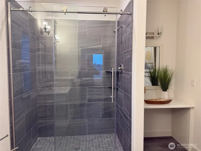 a bathroom with a shower and a sink