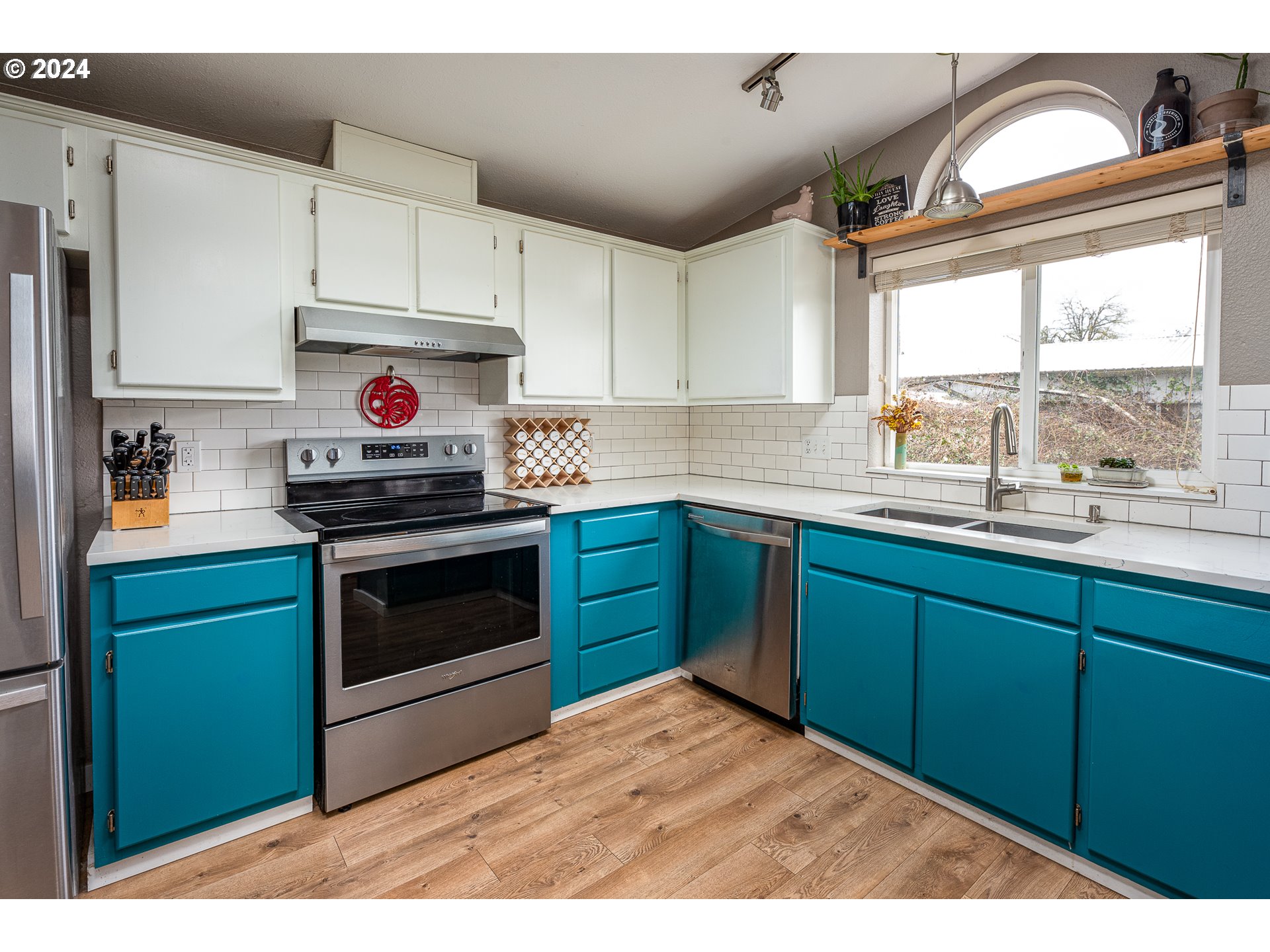 434 39th Street Springfield, OR 97478 - Photo 11 of 28 a kitchen with kitchen island granite countertop a stove a sink and dishwasher