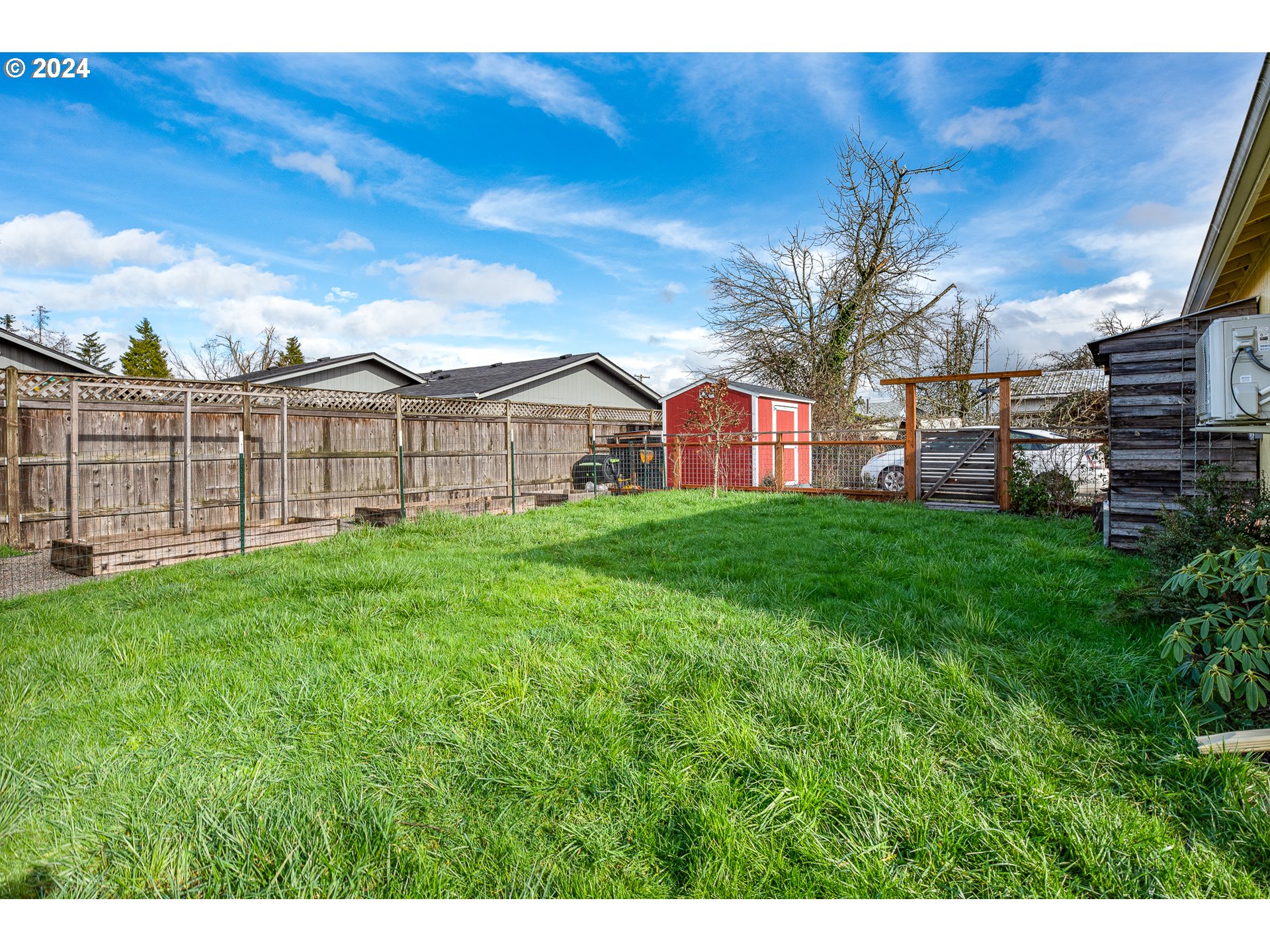 434 39th Street Springfield, OR 97478 - Photo 24 of 28 a view of a house with a big yard potted plants and large tree