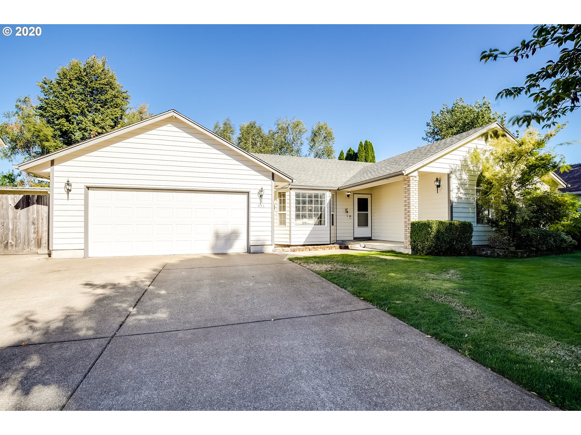 591 68th Place Springfield, OR 97478 - Photo 1 of 31 a view of a white house next to a yard with potted plants