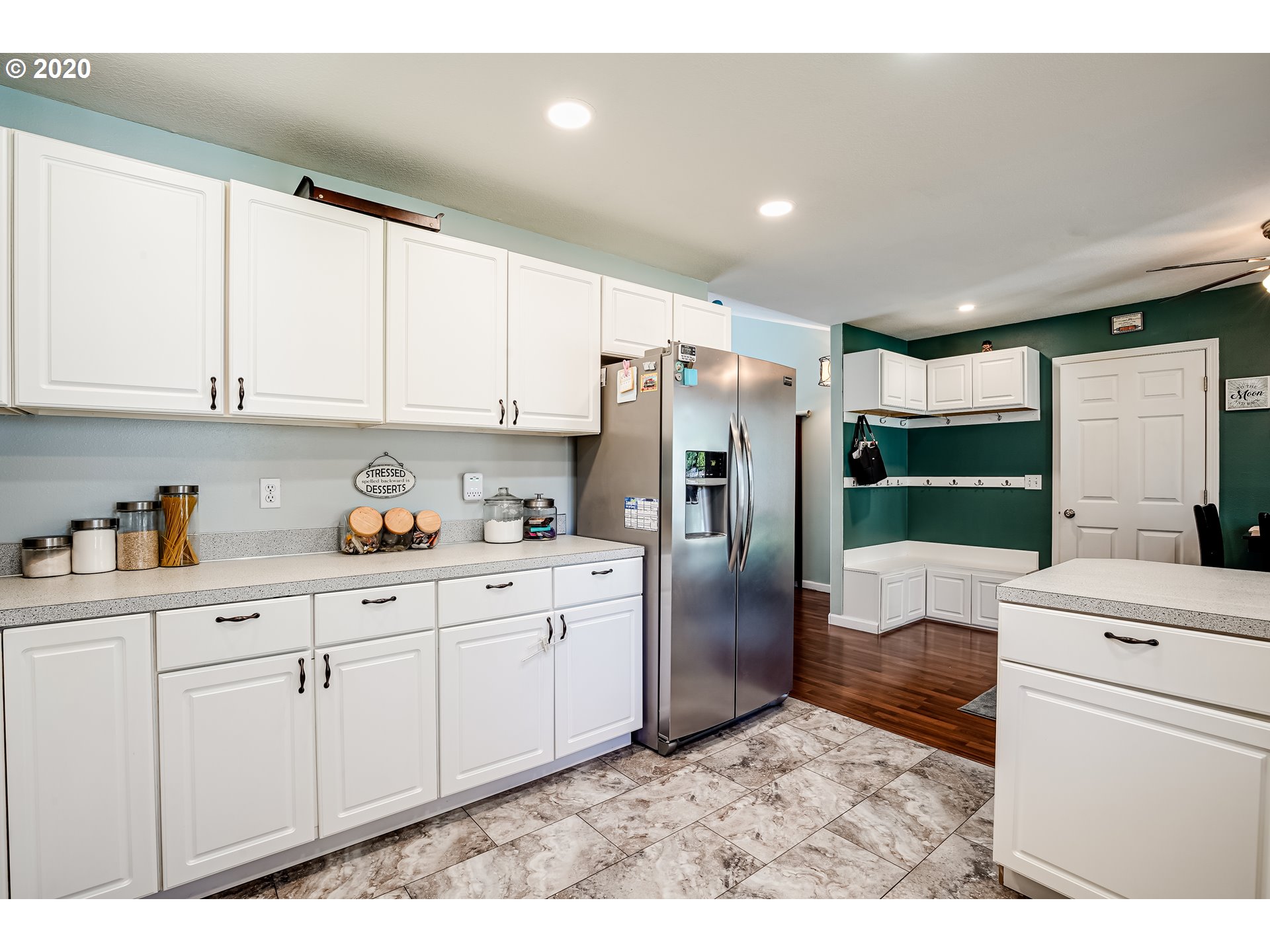 591 68th Place Springfield, OR 97478 - Photo 11 of 31 a kitchen with granite countertop white cabinets and refrigerator