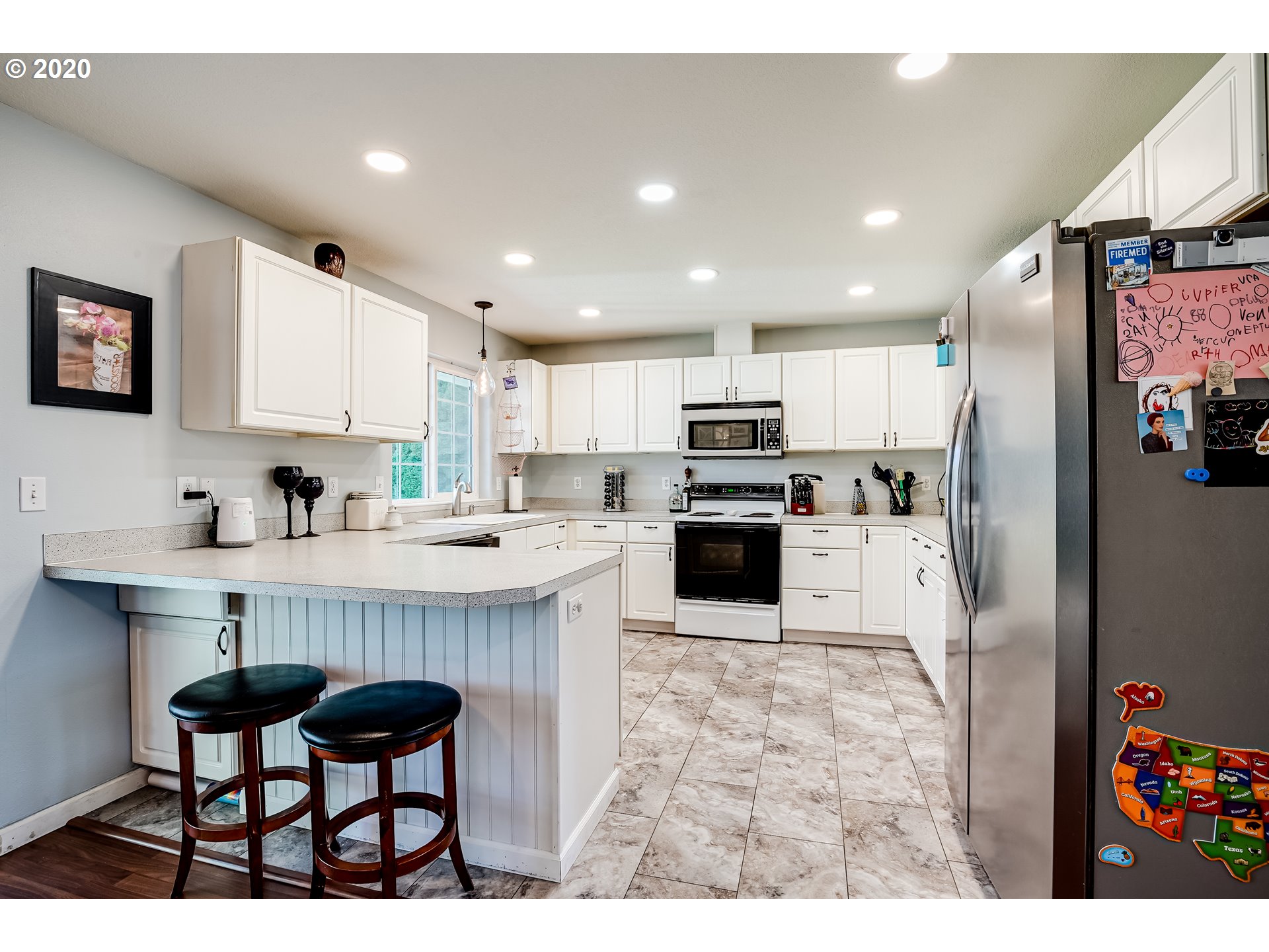 591 68th Place Springfield, OR 97478 - Photo 8 of 31 a kitchen with stainless steel appliances kitchen island granite countertop a refrigerator and a stove top oven
