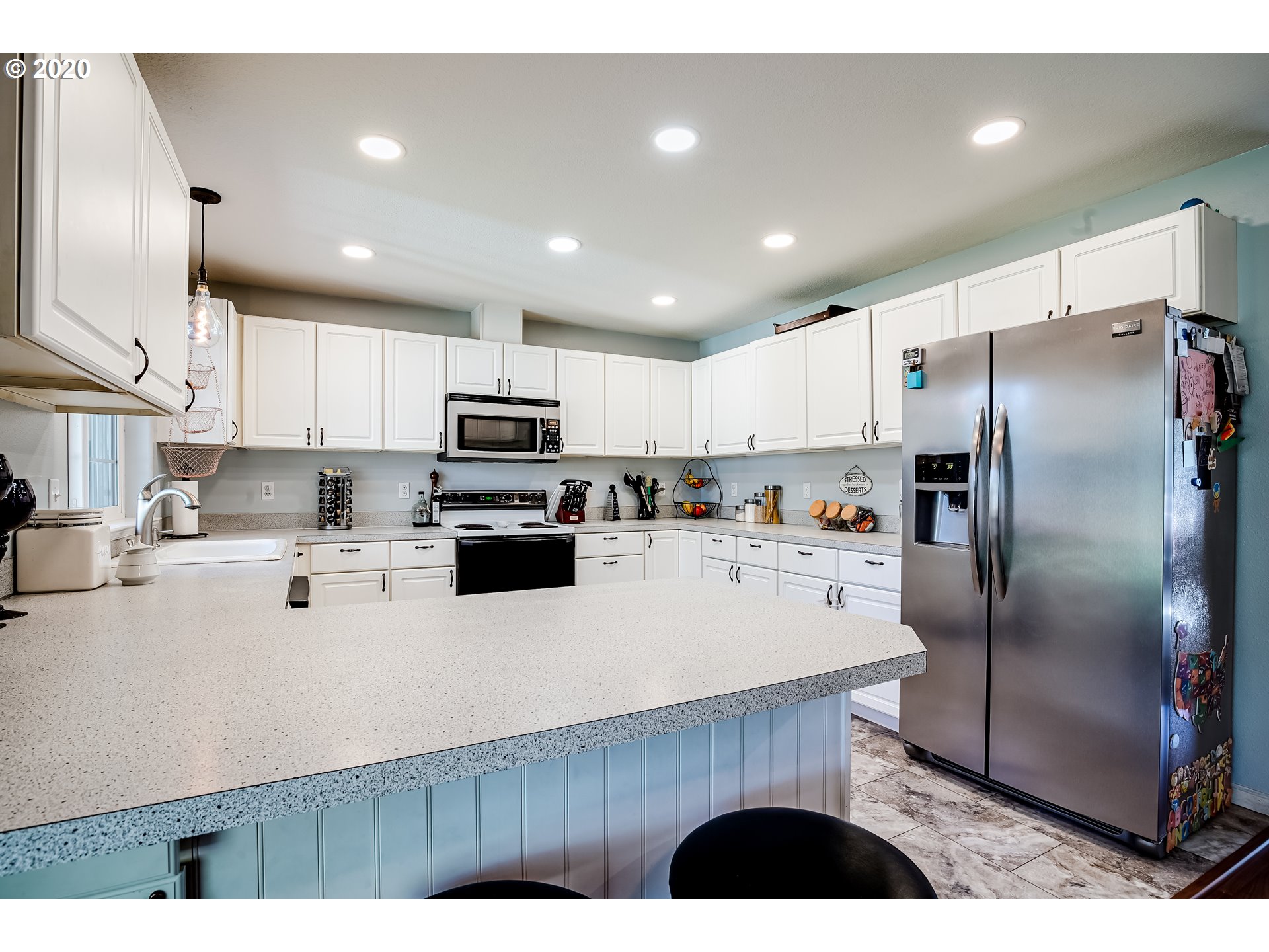 591 68th Place Springfield, OR 97478 - Photo 9 of 31 a kitchen with stainless steel appliances a refrigerator sink stove microwave and cabinets