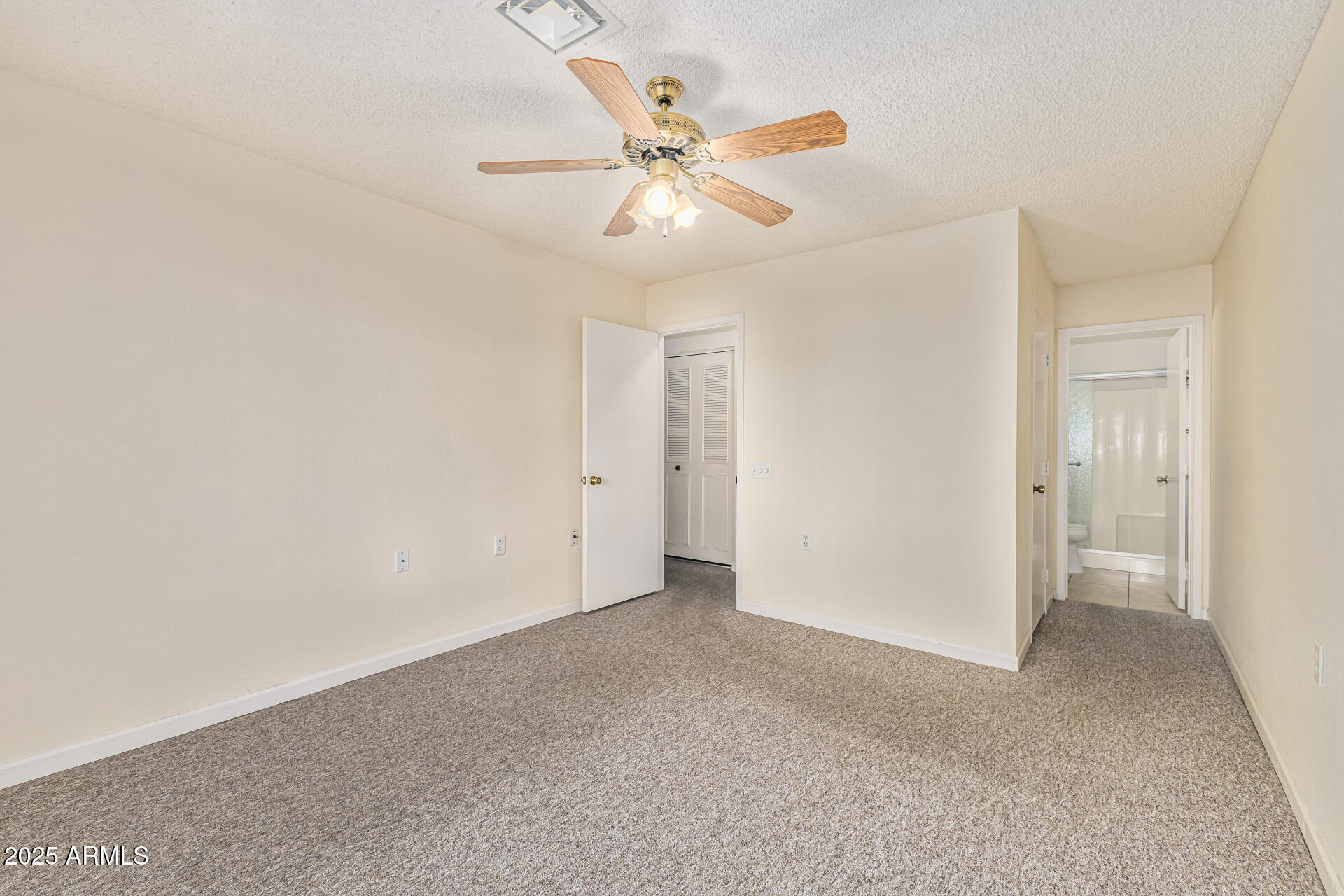 14300 West Bell Road, Unit 440 Surprise, AZ 85374 - Photo 17 of 40 a view of an empty room with a ceiling fan