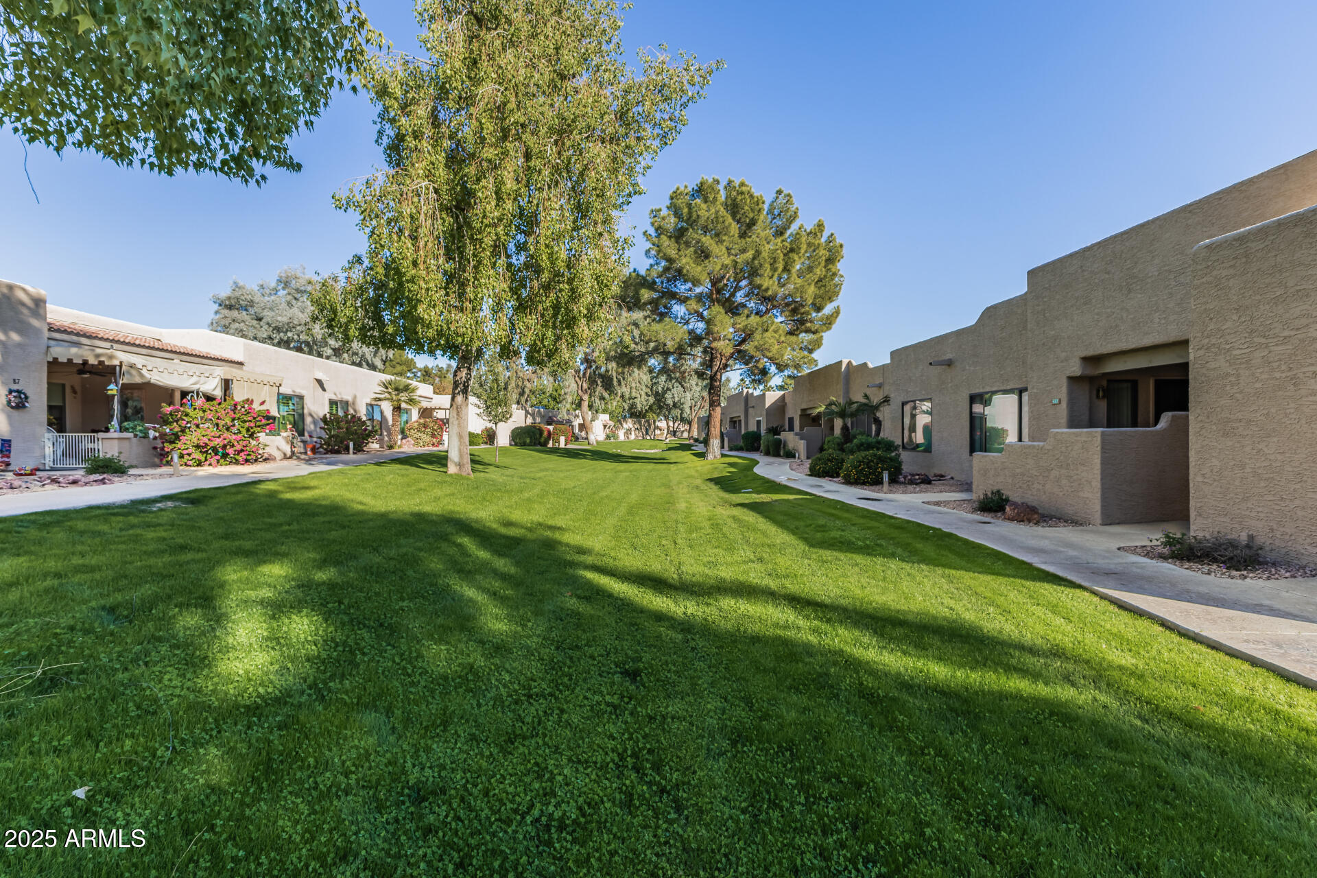 14300 West Bell Road, Unit 440 Surprise, AZ 85374 - Photo 25 of 40 a front view of a house with a yard table and chairs