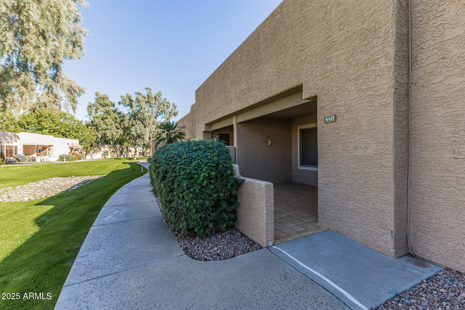 14300 West Bell Road, Unit 440 Surprise, AZ 85374 - Photo 2 of 40 a front view of a house with garden