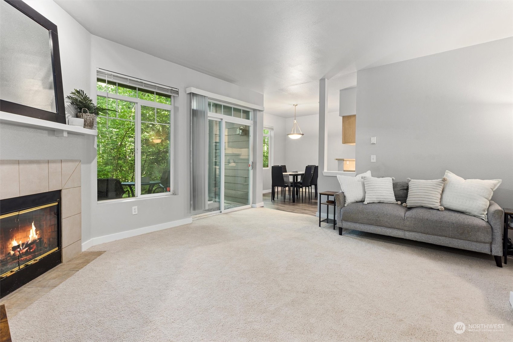 18930 Bothell Everett Highway, Unit C106 Bothell, WA 98012 - Photo 1 of 20 a living room with furniture a fireplace and a large window