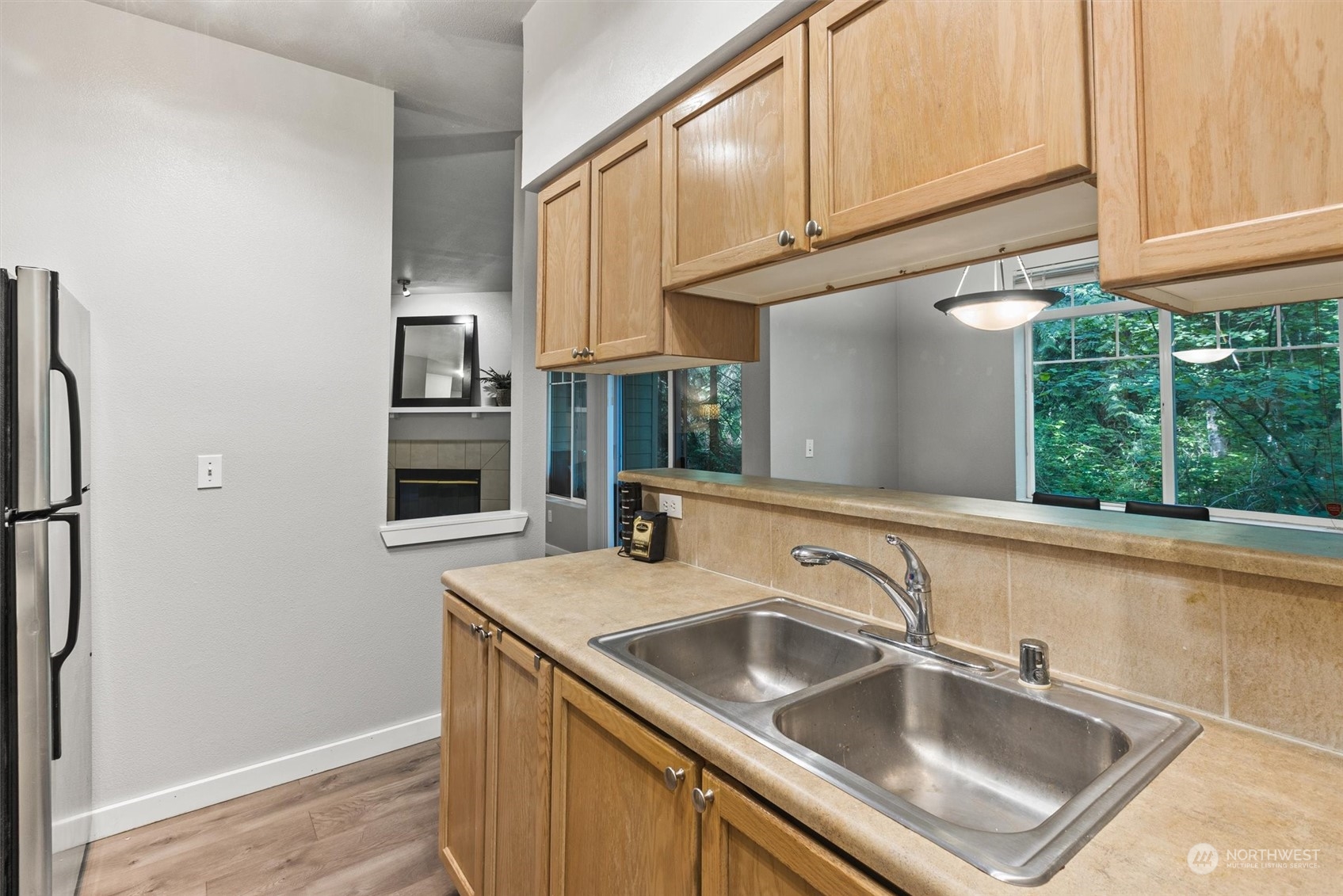 18930 Bothell Everett Highway, Unit C106 Bothell, WA 98012 - Photo 7 of 20 a kitchen with stainless steel appliances granite countertop a sink a refrigerator and a window