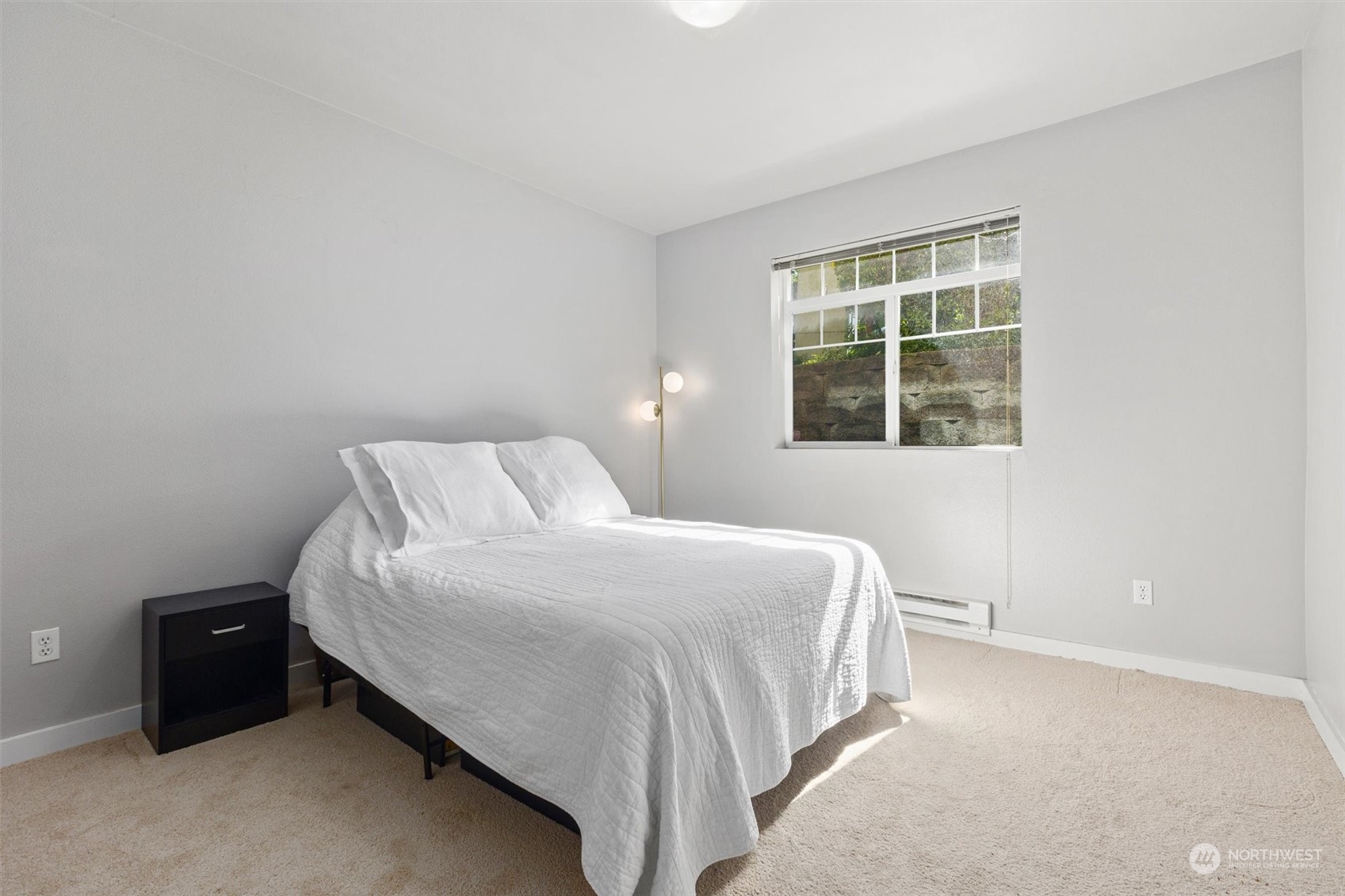 18930 Bothell Everett Highway, Unit C106 Bothell, WA 98012 - Photo 8 of 20 a bedroom with a bed and a window