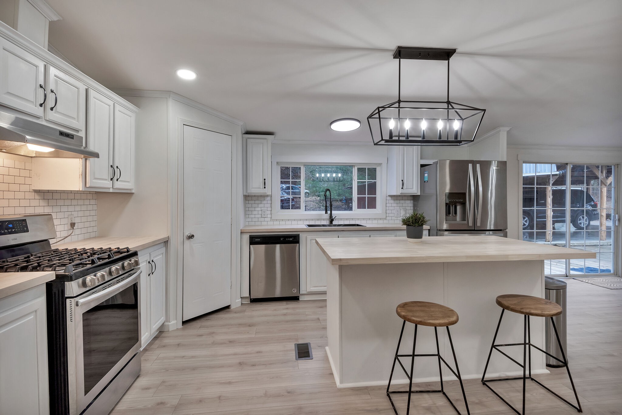3063 Sweethome Road Chapmansboro, TN 37035 - Photo 12 of 55 a kitchen with kitchen island granite countertop stainless steel appliances a stove sink and cabinets