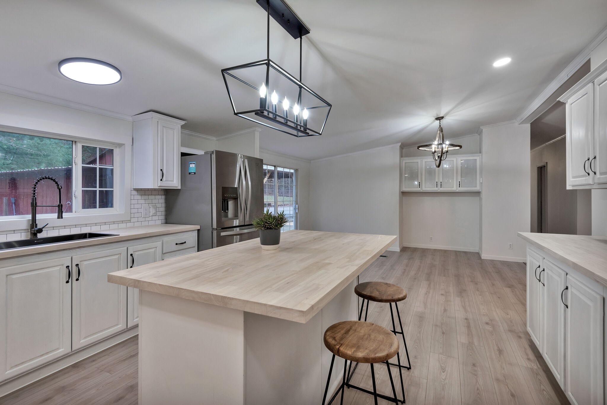 3063 Sweethome Road Chapmansboro, TN 37035 - Photo 13 of 55 a kitchen with stainless steel appliances granite countertop a sink a stove a dining table and chairs