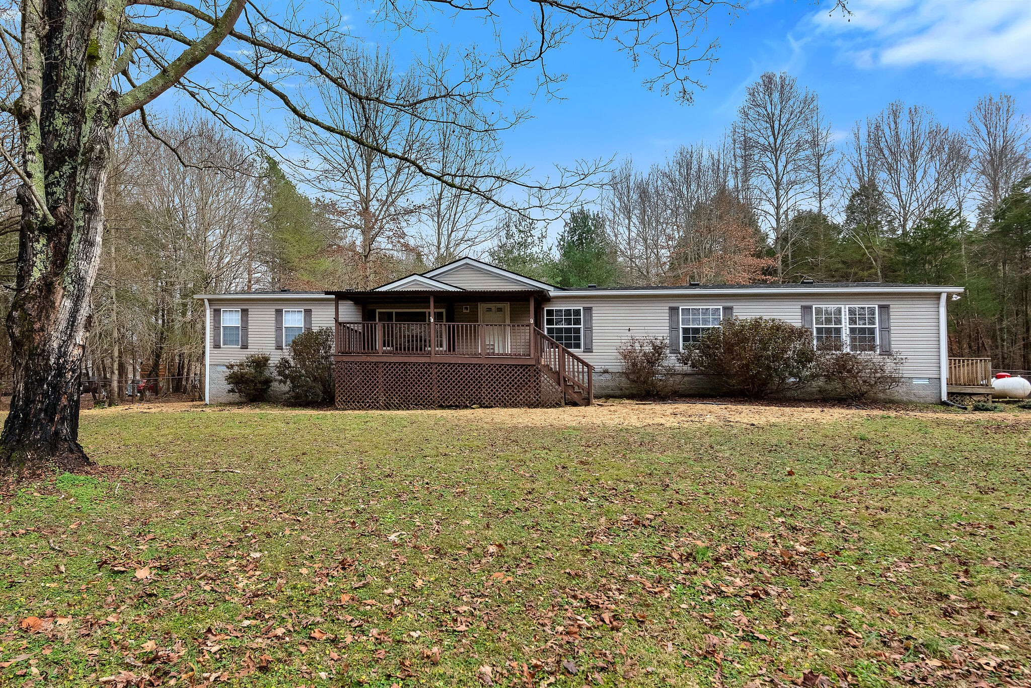 3063 Sweethome Road Chapmansboro, TN 37035 - Photo 2 of 55 a front view of a house with a yard and trees