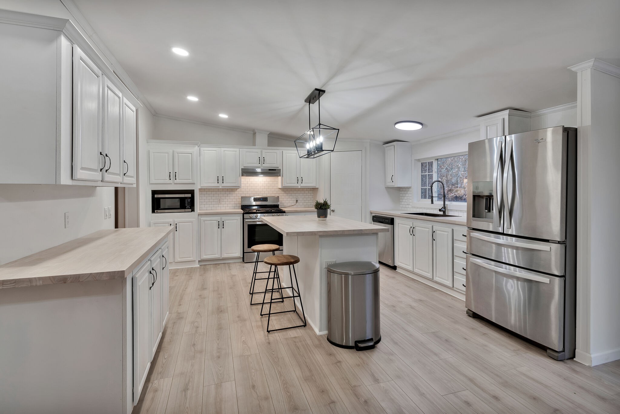3063 Sweethome Road Chapmansboro, TN 37035 - Photo 9 of 55 a kitchen with kitchen island white cabinets and stainless steel appliances