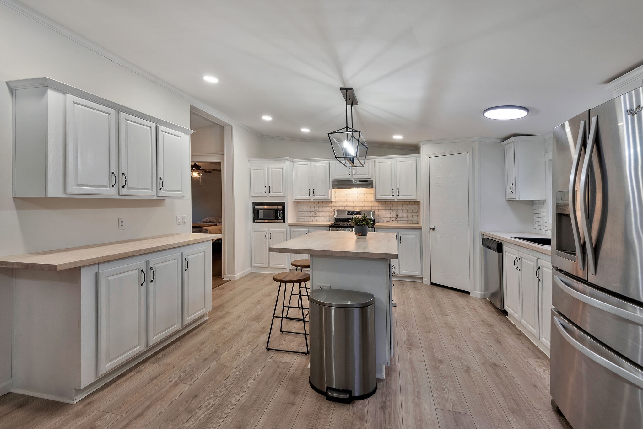 3063 Sweethome Road Chapmansboro, TN 37035 - Photo 10 of 55 a kitchen with white cabinets and stainless steel appliances
