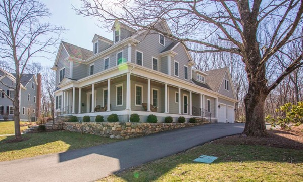 70 Deerfield Road Needham, MA 02492 - Photo 1 of 19 a front view of a house with a yard table and chairs