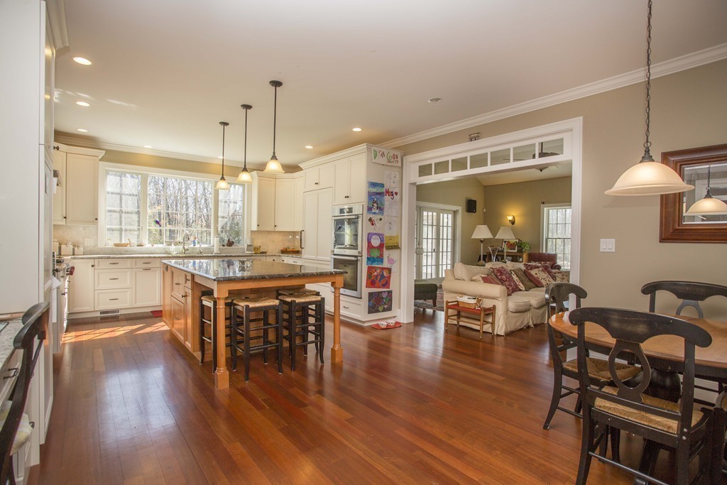 70 Deerfield Road Needham, MA 02492 - Photo 5 of 19 a large open kitchen with a table chairs and a wooden floor